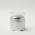Silver skincare jar with a white lid on a light gray background